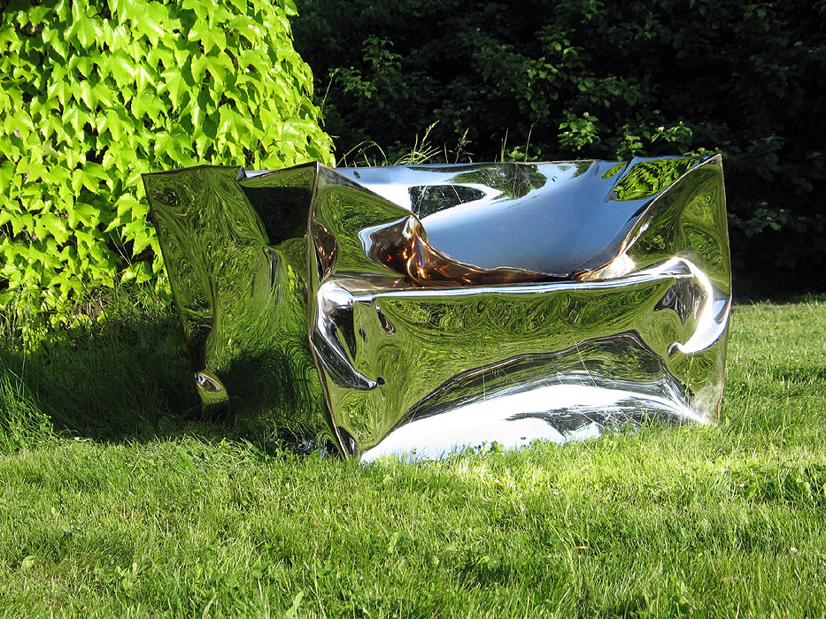 Mirror polished art funiture well-placed in a beautiful garden